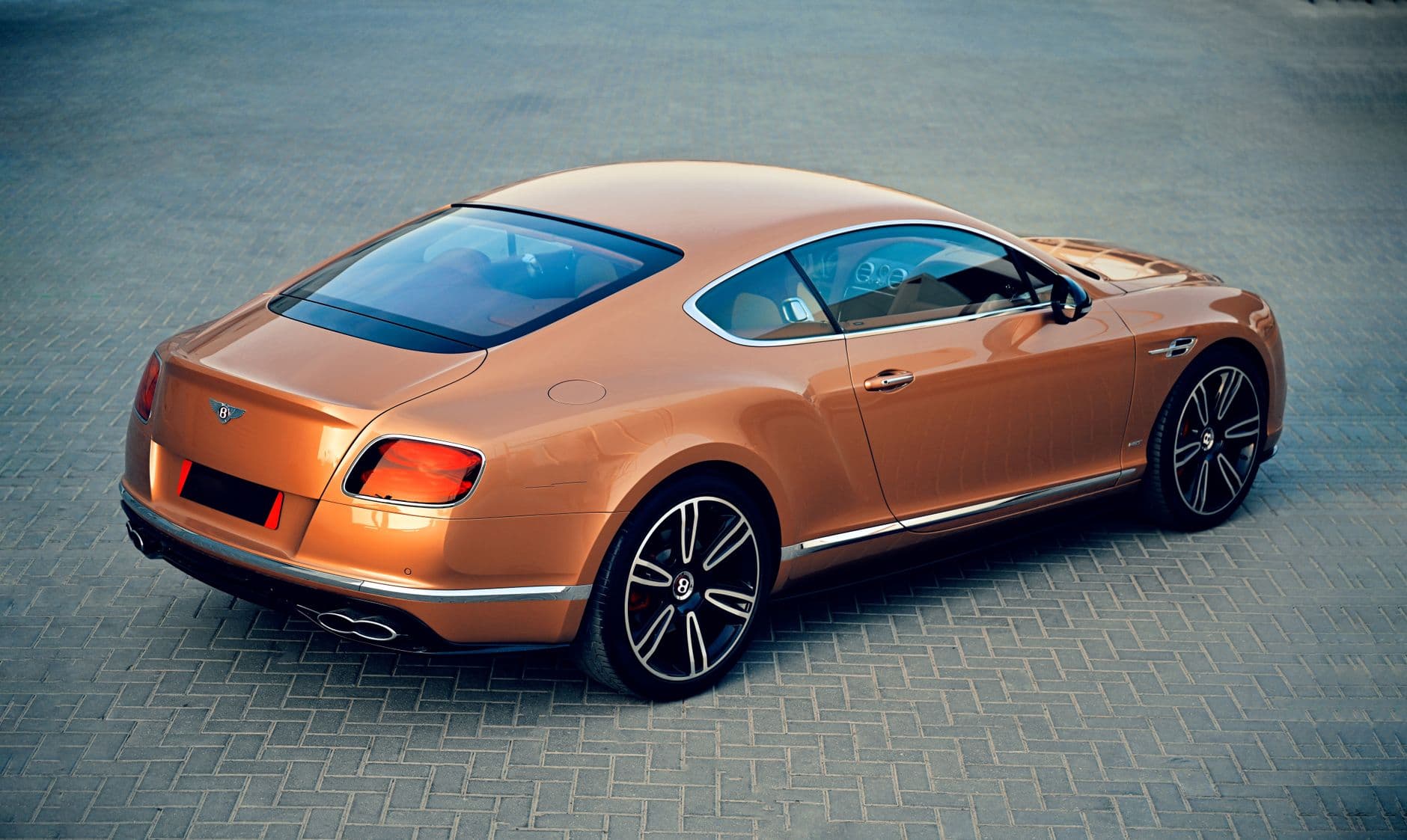 2026 red Bentley Continental GT convertible parked in front of Burj Al Arab in Dubai